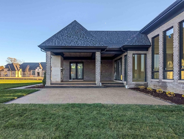 rear view of property with a porch and a yard