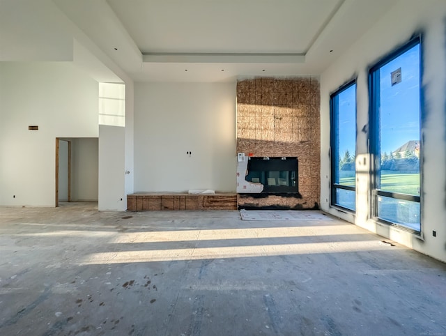 unfurnished living room with a raised ceiling