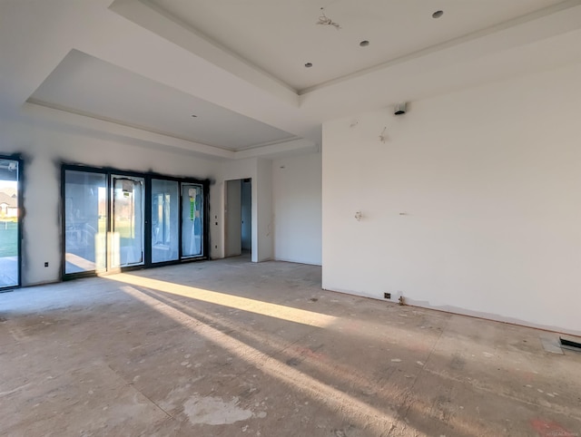 unfurnished room with a tray ceiling