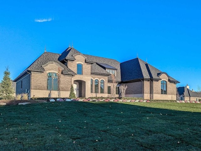 french country inspired facade featuring a front yard