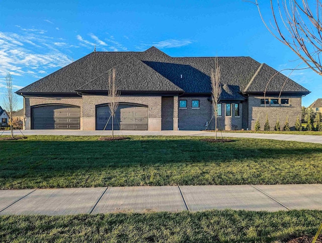 view of front of home with a front lawn and a garage