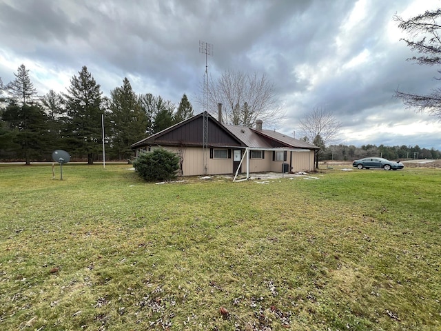 view of side of home with a yard