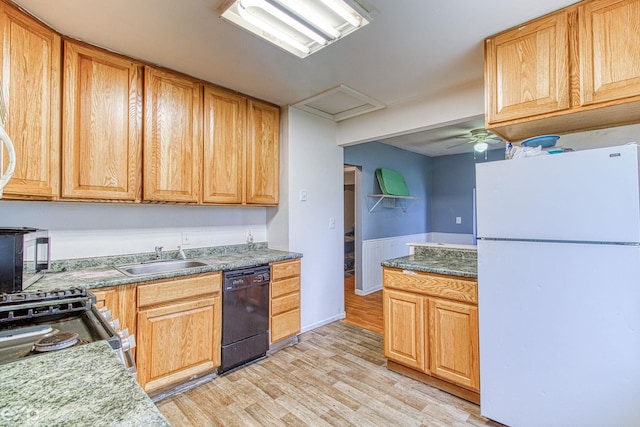 kitchen featuring dishwasher, white refrigerator, sink, stainless steel stove, and light hardwood / wood-style floors