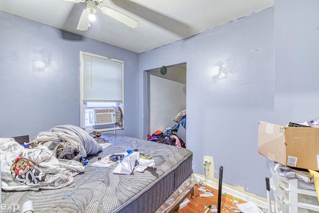 bedroom featuring ceiling fan, cooling unit, and hardwood / wood-style flooring