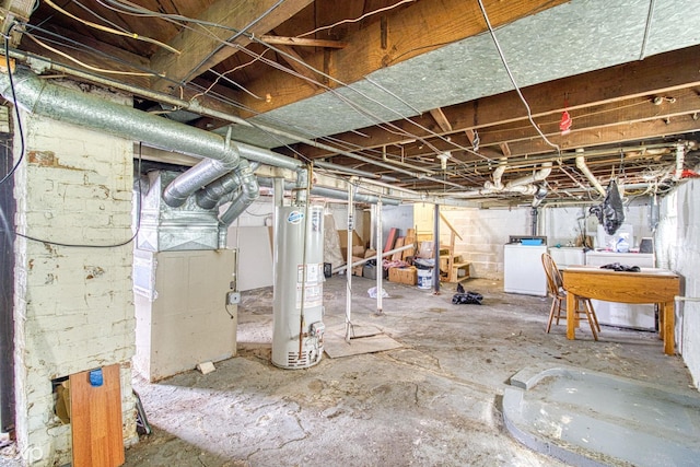 basement featuring washing machine and dryer and gas water heater