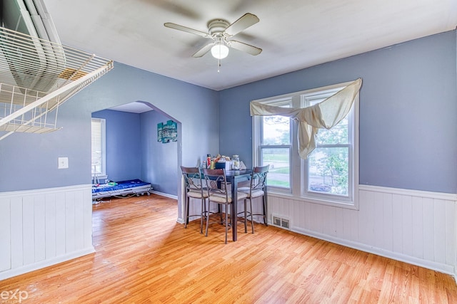 dining area featuring wood-type flooring and ceiling fan