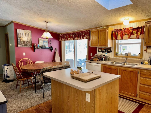 kitchen featuring a center island, white dishwasher, sink, hanging light fixtures, and dark hardwood / wood-style floors