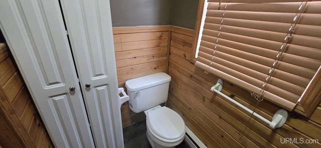 bathroom featuring wood walls and toilet