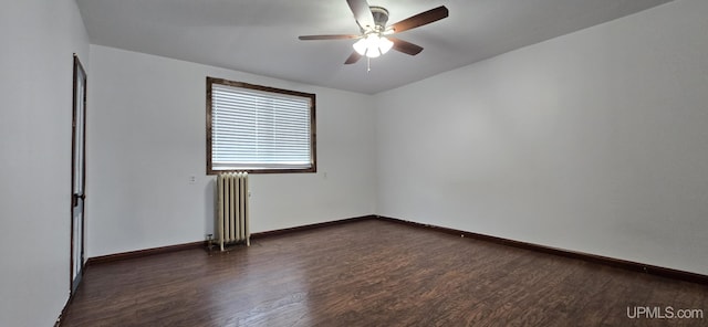 spare room with ceiling fan, dark hardwood / wood-style flooring, and radiator heating unit