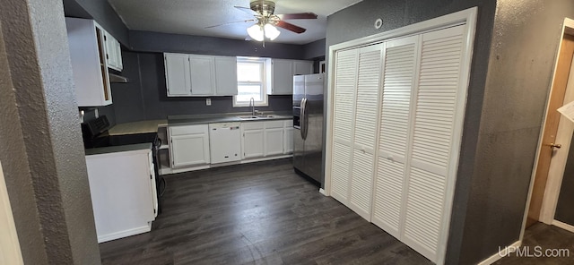 kitchen with white dishwasher, sink, stainless steel fridge, dark hardwood / wood-style flooring, and white cabinetry