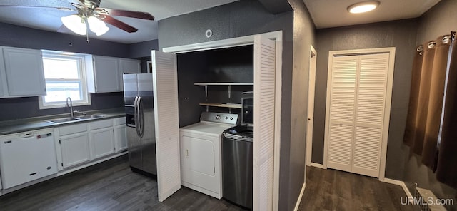 kitchen with dishwasher, stainless steel fridge, white cabinetry, and sink