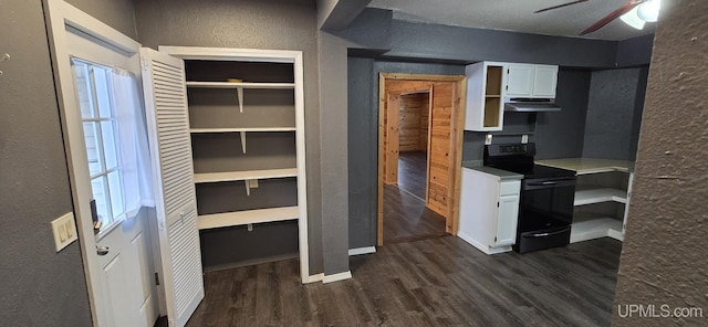 kitchen featuring white cabinets, black / electric stove, dark wood-type flooring, and ceiling fan