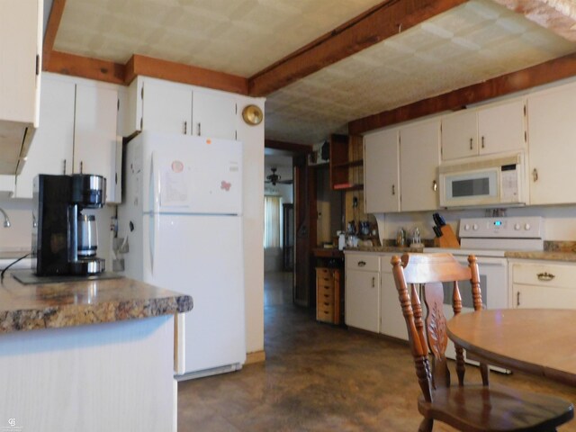 kitchen with white cabinetry and white appliances