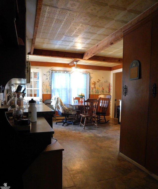 dining area with beam ceiling