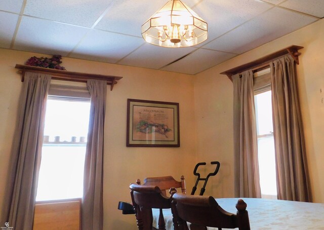 dining room featuring a drop ceiling and an inviting chandelier