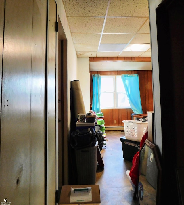 bedroom featuring a drop ceiling and a baseboard radiator