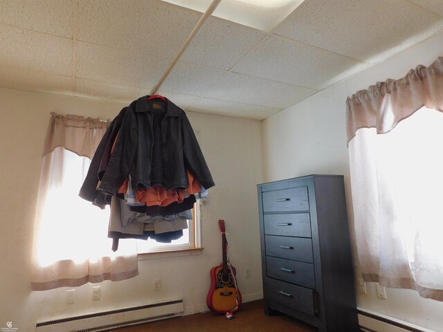 interior space featuring a paneled ceiling and a baseboard radiator