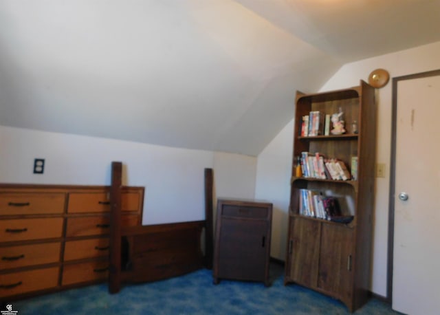 bedroom featuring dark carpet and lofted ceiling