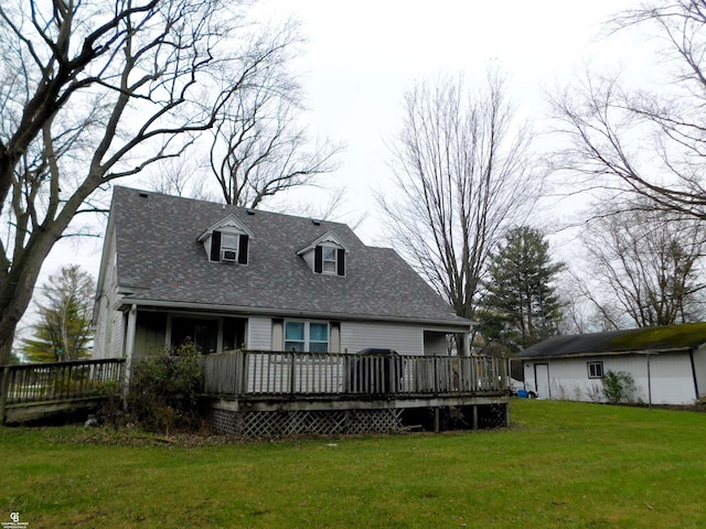 back of property with a yard and a wooden deck