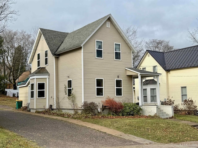 view of side of home with a yard