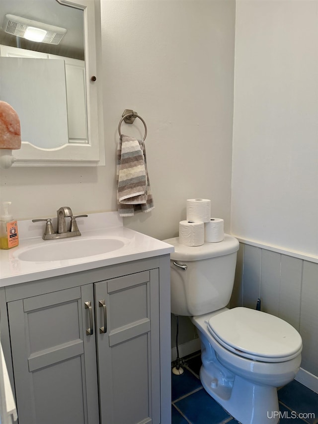 bathroom featuring tile patterned floors, vanity, and toilet