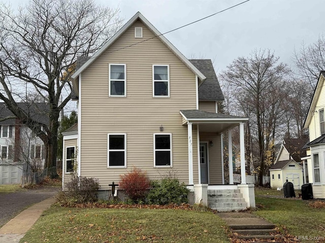 front facade featuring a porch and a front yard