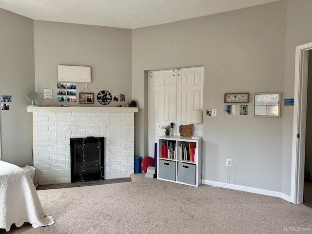 carpeted living room with a brick fireplace