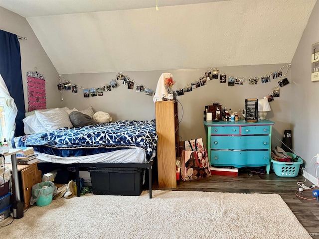 bedroom with dark hardwood / wood-style floors and lofted ceiling