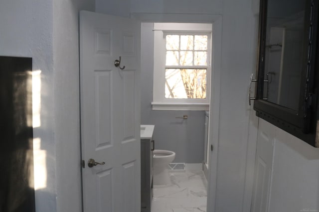 bathroom featuring vanity and toilet