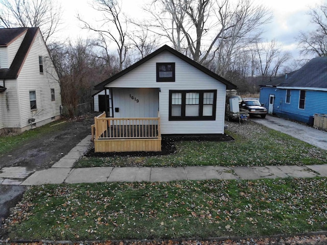 bungalow with a porch and a front yard