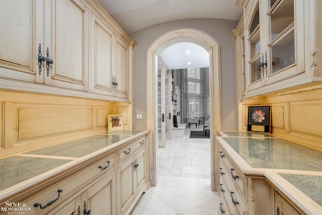 bar featuring light brown cabinetry