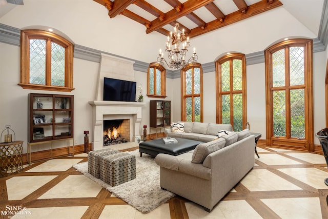 living room with a high ceiling, a wealth of natural light, and a notable chandelier