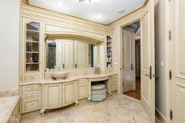 bathroom with vanity and ornamental molding