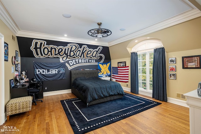 bedroom featuring hardwood / wood-style floors and crown molding