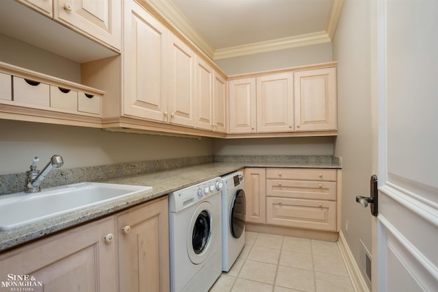 laundry room featuring sink, cabinets, separate washer and dryer, light tile patterned floors, and ornamental molding