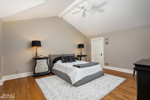 bedroom featuring vaulted ceiling with beams, hardwood / wood-style flooring, and ceiling fan