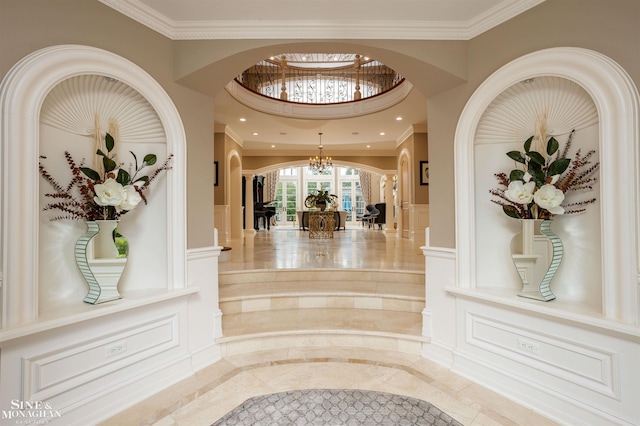 interior space with crown molding and a notable chandelier