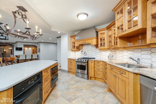 kitchen with sink, hanging light fixtures, decorative backsplash, black appliances, and custom exhaust hood