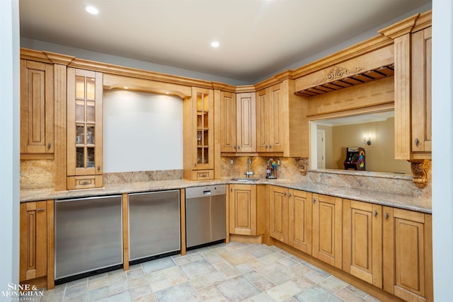 kitchen featuring sink, light stone countertops, stainless steel appliances, and tasteful backsplash