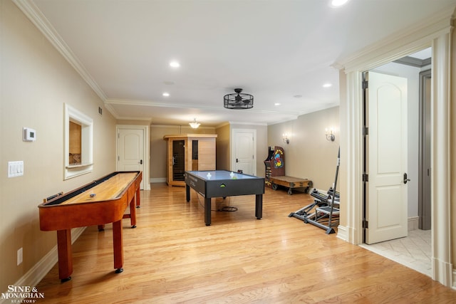 game room with light hardwood / wood-style flooring and ornamental molding