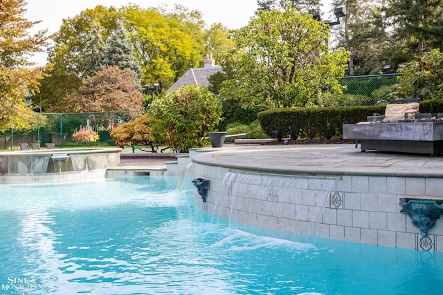 view of pool with pool water feature