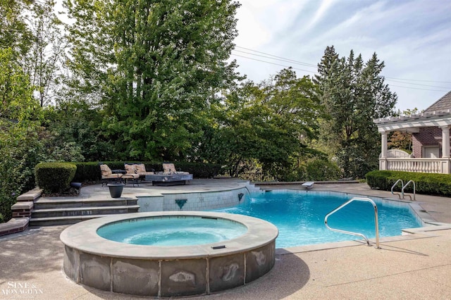 view of pool featuring a patio area and an in ground hot tub