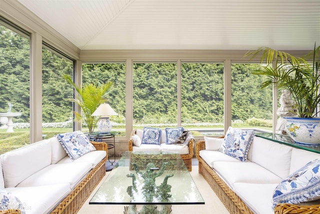 sunroom / solarium featuring a healthy amount of sunlight and vaulted ceiling