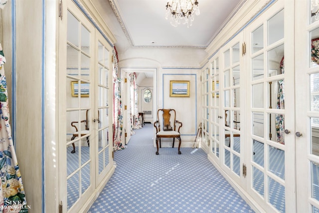 interior space featuring a notable chandelier, carpet floors, crown molding, and french doors