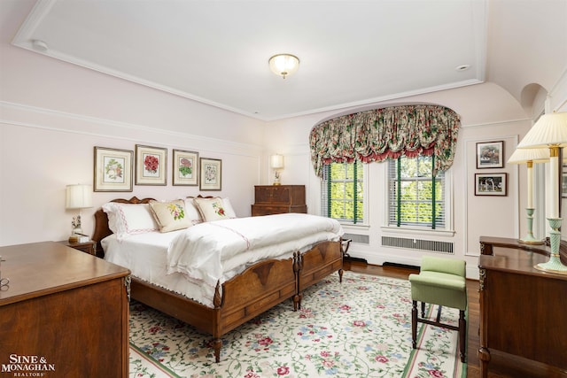 bedroom with crown molding and light hardwood / wood-style flooring