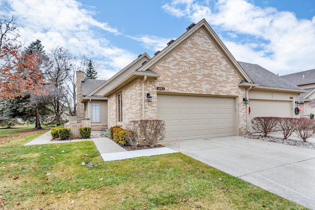 view of front of property with a garage and a front lawn