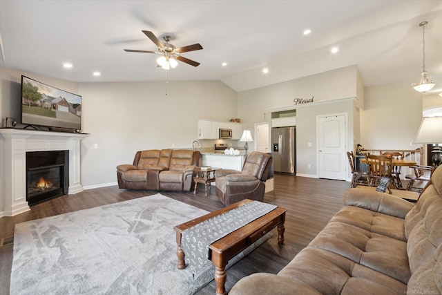 living room with ceiling fan, dark hardwood / wood-style flooring, and lofted ceiling