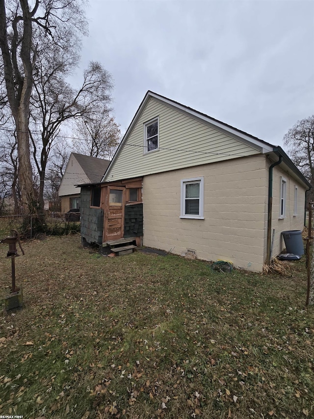 back of house with a lawn