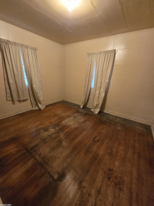 unfurnished room featuring dark wood-type flooring