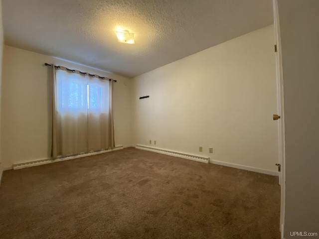 carpeted spare room featuring a textured ceiling and a baseboard radiator